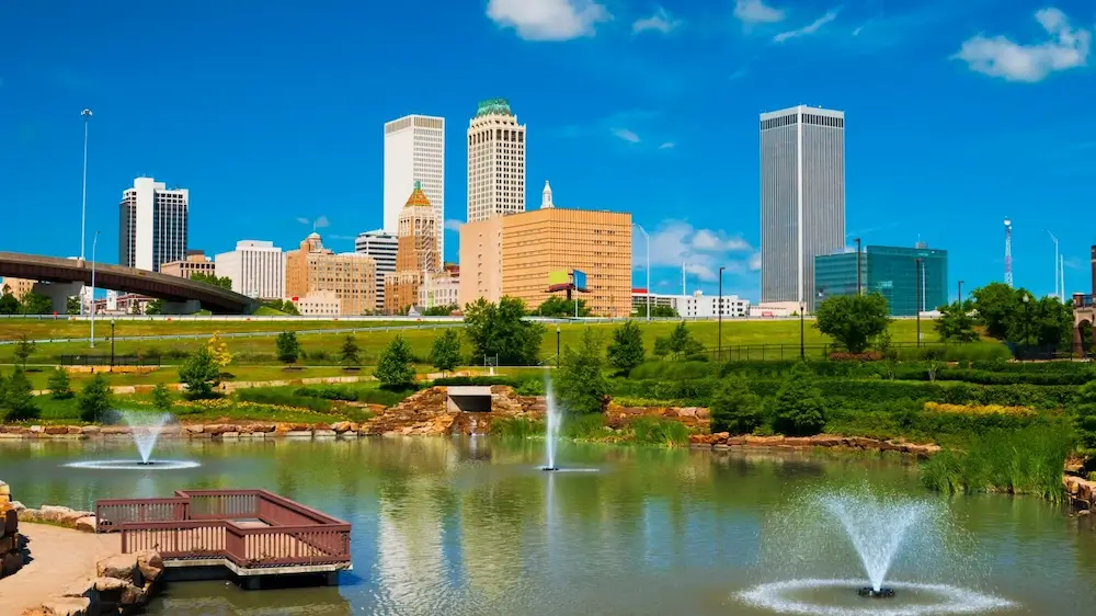 a photo of a park in Tulsa, with downtown in the background